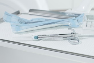 A carpal syringe, reusable, for use in dentistry, for the administration of anesthetic, lies on the