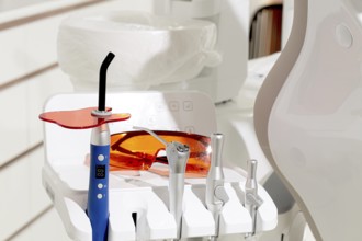 Dental instruments, photopolymer lamp, safety glasses, on a modular table