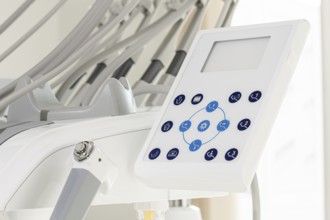 A close-up view of a dental equipment control panel showcasing various settings. This setup is