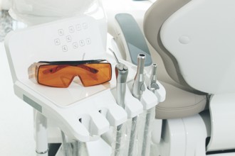 Dental instruments and safety glasses on the module, there are no people in the dental clinic