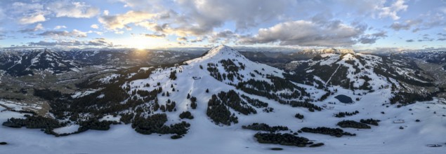 Sunset, alpine panorama, fantastic winter landscape with Hohe Salve, blue sky and snow, mountains