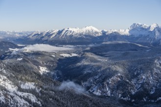 View of snow-covered mountain landscape across the Reintal towards the Estergebirge and