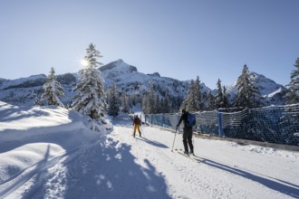 Ski tourers in snowy mountain scenery in the Garmisch Classic ski area, view of the Alpspitze