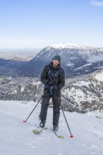 Happy ski tourer climbing to Längenfelderkopf, in winter, Wetterstein Mountains,