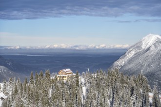 Snowy forest and Kreuzeckhaus mountain hut in the Garmisch Classic ski area in winter, Wetterstein