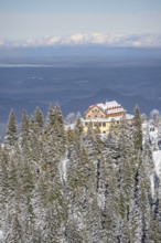 Snowy forest and Kreuzeckhaus mountain hut in the Garmisch Classic ski area in winter, Wetterstein