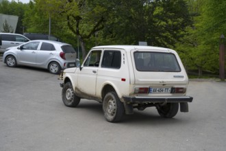 White Lada on a rural road in a green area, Imereti region, Imereti, Georgia