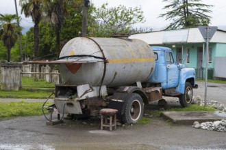 Old truck with gas tank on a rural road in rural area, gas bottles can be filled, Imereti region,