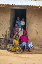 African woman and children in the house entrance, in a Sadaani village, Tanga, Tanzania