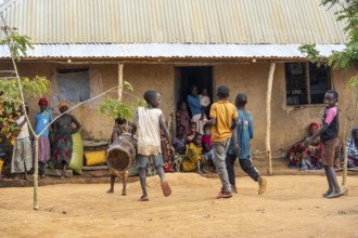 Residents in the main house of a village, children with drums, in a Sadaani village, Tanga,