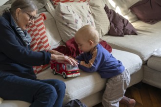 Great-grandmother playing with her great-grandson, two years old, Othenstorf, Mecklenburg-Western
