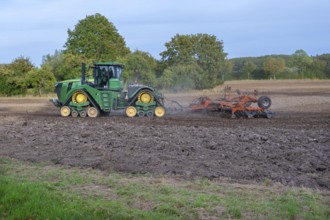 Crawler tractors harrow the field, Othenstorf, Mecklenburg-Western Pomerania, Germany