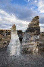 Eroded rock formations, volcanic landscape with dramatic cloudy skies, Ciudad Estratificada or Los