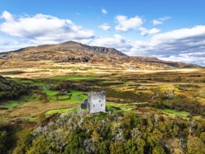 Autumn colours over Castell Dolwyddelan and Eryri Mountains from a drone, Snowdonia, Conwy County