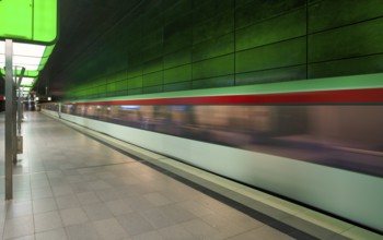 HafenCity University underground station, illuminated in color, green, underground train, movement