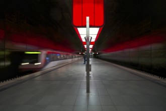 HafenCity University underground station, illuminated in color, red, underground train, movement