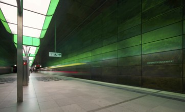 HafenCity University underground station, illuminated in color, green, underground train, motion