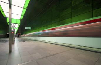 HafenCity University underground station, illuminated in color, green, underground train, movement