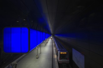 HafenCity University subway station, illuminated in color, blue, underground train, U4, travelers,