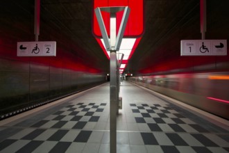 HafenCity University underground station, illuminated in color, red, underground train, movement