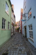 Colourful houses with shops and half-timbered houses in a small alley, picturesque district with