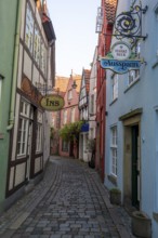Colourful houses with shops and restaurants, half-timbered houses in a small alley, picturesque