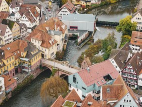 Central urban area with half-timbered buildings and river bridges in autumn surroundings, Calw,