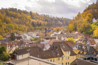 Urban autumn landscape with roofs and wooded hills, Calw, Black Forest, Germany