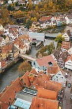 View of a historic old town with a river, half-timbered houses and a bridge in autumn, Calw, Black
