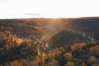 Wide view of an autumn forest and hills under a sunset sky, Calw, Black Forest, Germany