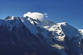 From left snow-covered Aiguille du Midi, Mont-Blanc in the clouds, Vallot Hut, Chamonix-Mont-Blanc,