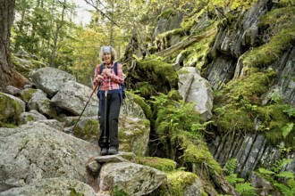 Female hiker on mountain tour standing in rocky terrain, Mont-Blanc, Chamonix-Mont-Blanc,