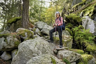 Female hiker on mountain tour standing in rocky terrain, Mont-Blanc, Chamonix-Mont-Blanc,