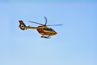 Helicopter flying against a blue sky, alpine rescue, mountain rescue, Chamonix, Haute-Savoie,