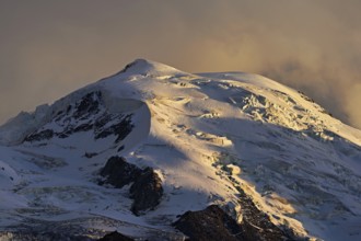 Snow-covered Dome du Goûter, in the evening light, Chamonix-Mont-Blanc, Haute-Savoie, France