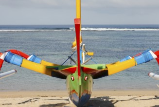 Colourfully painted outrigger fishing boats, (Junkung), on Sanur beach, Bali, Indonesia