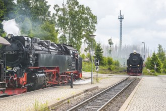 Front and side of steaming railway locomotives, two steam locomotives, steam locomotive, rails and