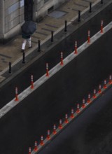 Man with umbrella walking on a street, from above, street scene, Belgrade, Serbia