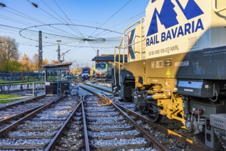 Railway tracks and turntable above a catenary spider, parked Rail Bavaria locomotive, Augsburg