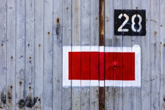 Protection signal with red and white paint at entrance gate No. 28 to the old engine shed, Augsburg