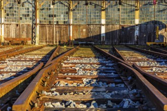 Railroad tracks lead to the entrance gates at the old engine shed, Augsburg railway park,