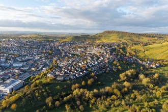 Panoramic picture of a village in evening light surrounded by hills and nature, autumn,
