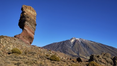 Distinctive rocky outcrop in front of volcano in barren surroundings, UNESCO World Heritage Site,