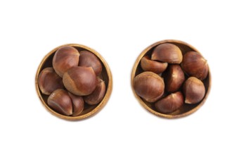 Wooden bowl with raw edible ?hestnuts Isolated on white background, top view, flat lay, close up,