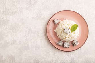 White ?ottage cheese, Curd, with Pithaya on gray concrete background, top view, flat lay, copy