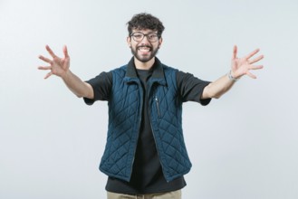 Friendly guy welcoming with open arms isolated. Cheerful young man welcoming you with open arms