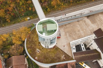 Tower with balcony and parking area, surrounded by autumn leaves and railroad tracks, Hermann