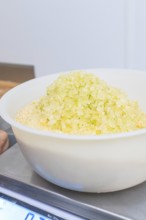 Close-up of a bowl of yellow sugar on a scale in a kitchen, Christmas baking, Haselstaller Hof,