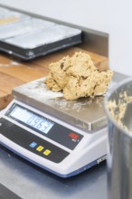 Dough ball placed on a digital scale in a kitchen, weight displayed, Christmas baking, Haselstaller
