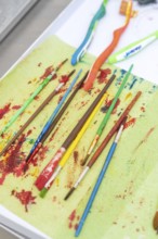 Colourful brushes and toothbrushes on a table, connected to an art project, Weihnachtsbacken,